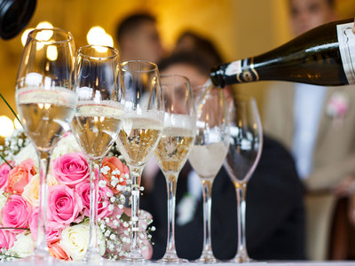 line of champagne glasses being filled with champagne
