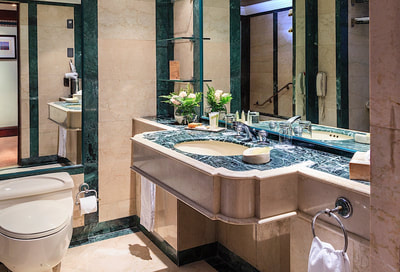 granite stone bathroom with large mirrors 
