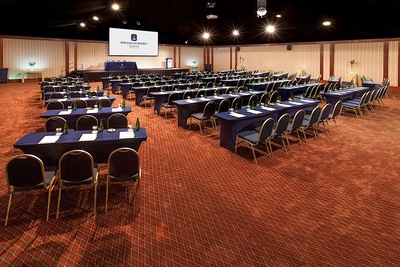 conference room with rows of tables and chairs