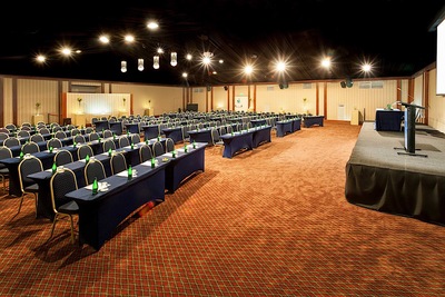 large conference room with rows of tables and chairs 